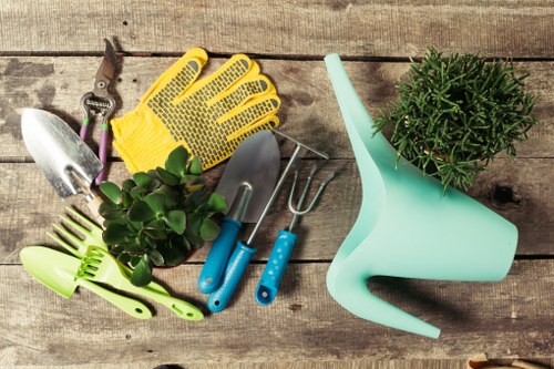 Gardener preparing to trim a hedge with safety gear